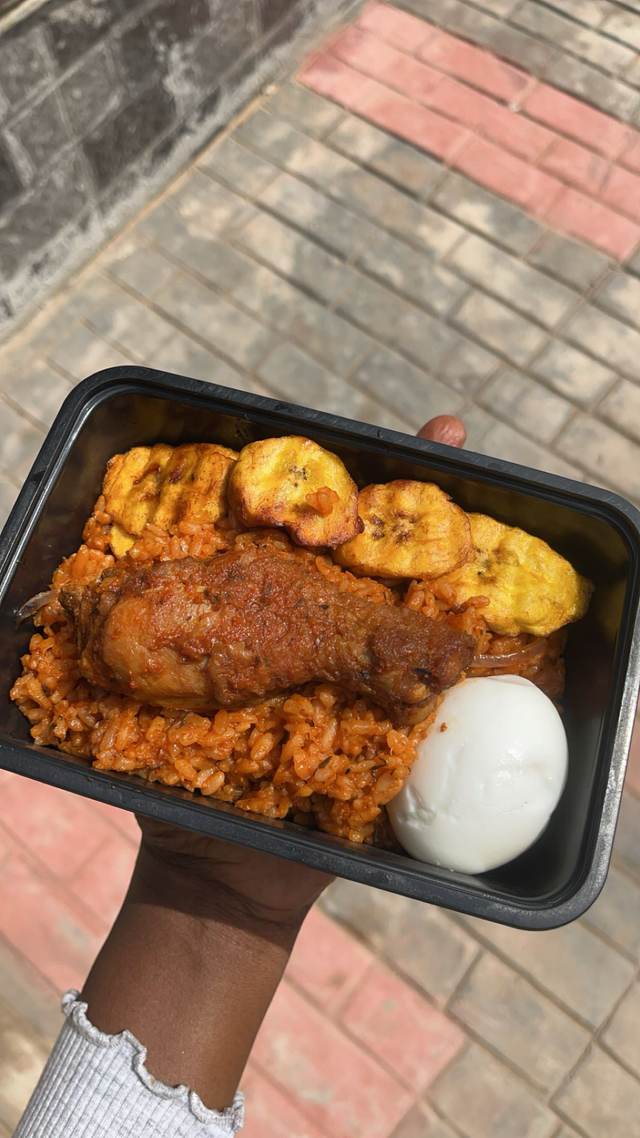 Jollofrice, peppered chicken, plantain and Boiled egg